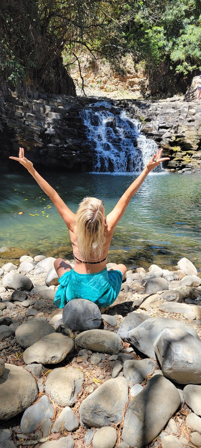Bren enjoying a waterfall in Maui’s lush landscape