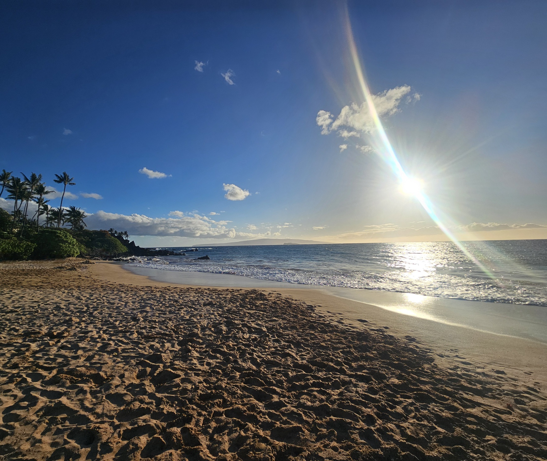 Rainbow meeting the ocean along the Maui coast